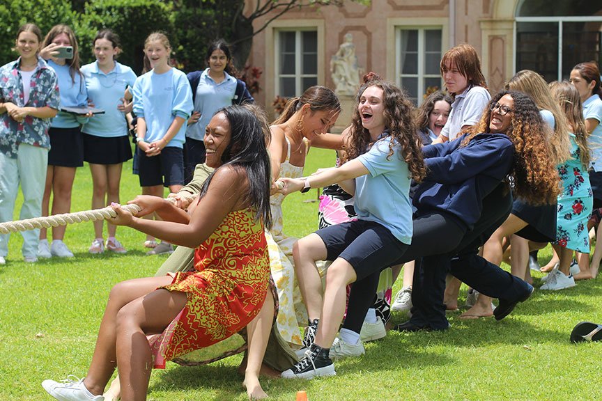 Seniors take on faculty and staff members during a tug-of-war match on May Day.