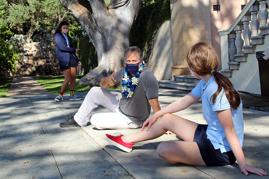 Pisculli demonstrates how a character might sit during a portion of the scene.