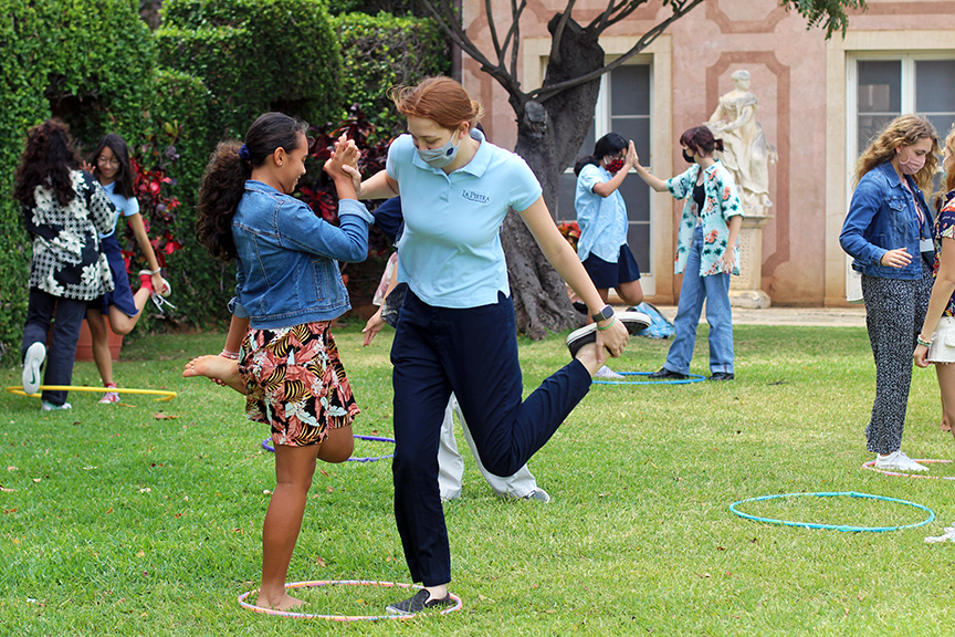 Freshmen go head to head in a chicken fighting game at the haka moa circle.