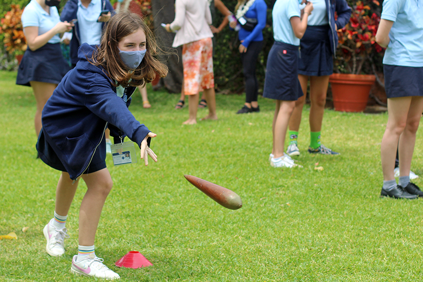 7th grader Estella L. plays moa pahe’e on the Great Lawn.