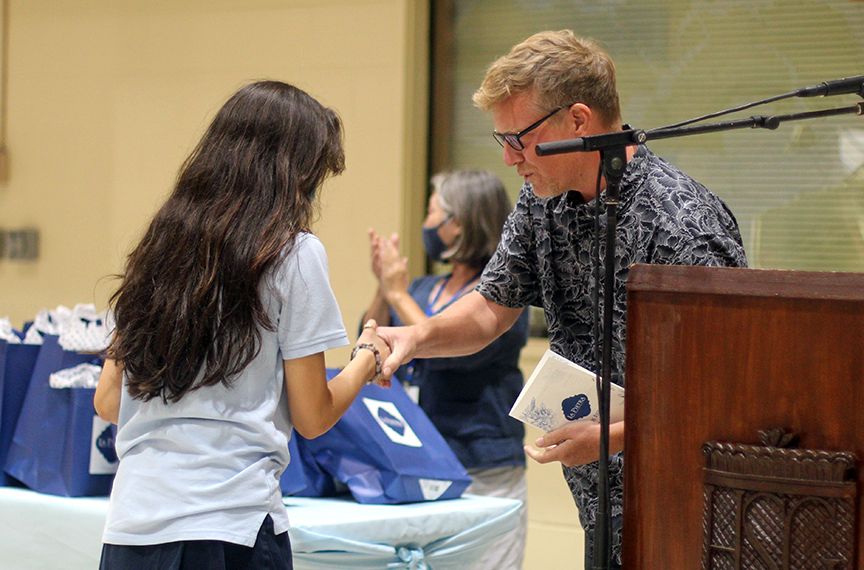 Senior Alexa C. receives her certificate and gift from Mr. Ben Roosevelt for Excellence in English.