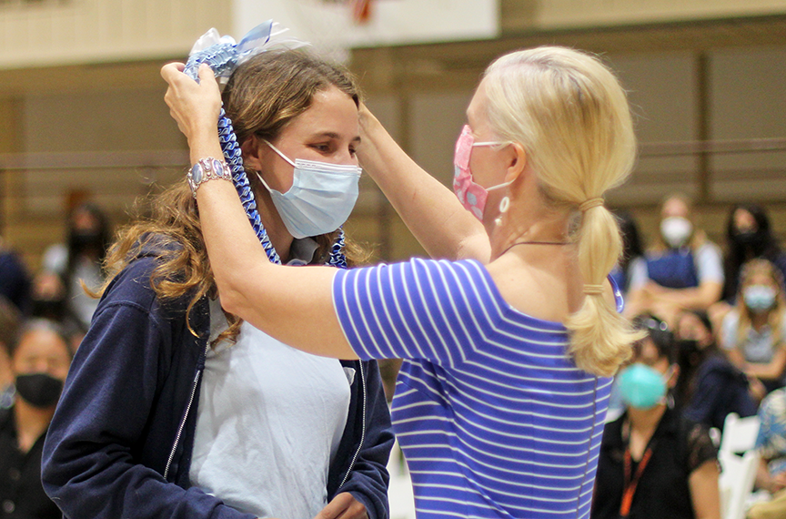 Senior Emma R. receives a lei from her mom after winning the French Award.