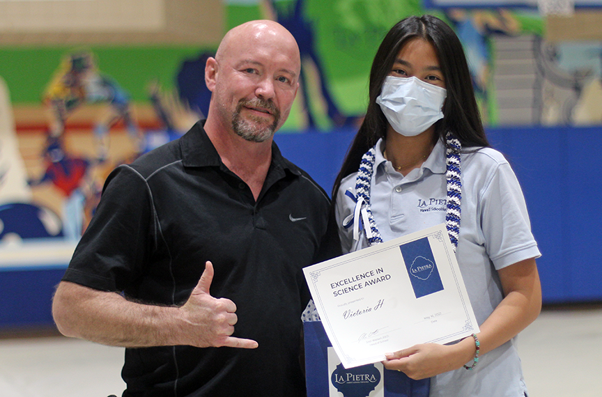 Mr. Aaron Sekulich honors seniors Victoria H. with the Excellence in Science Award, one of many awards she received that day.