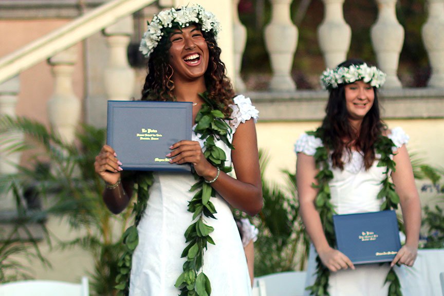 Mayara S. receives her diploma. 