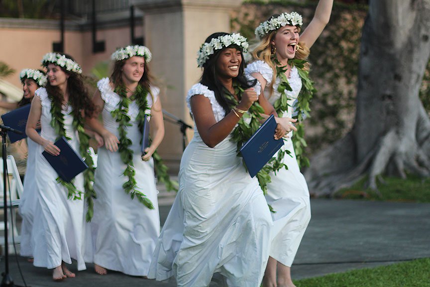 Nina B. and Jade H. lead the recessional as the new graduates celebrate.