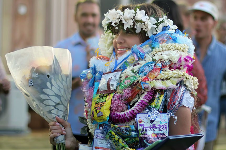 Kierra A. buried in a sea of lei.