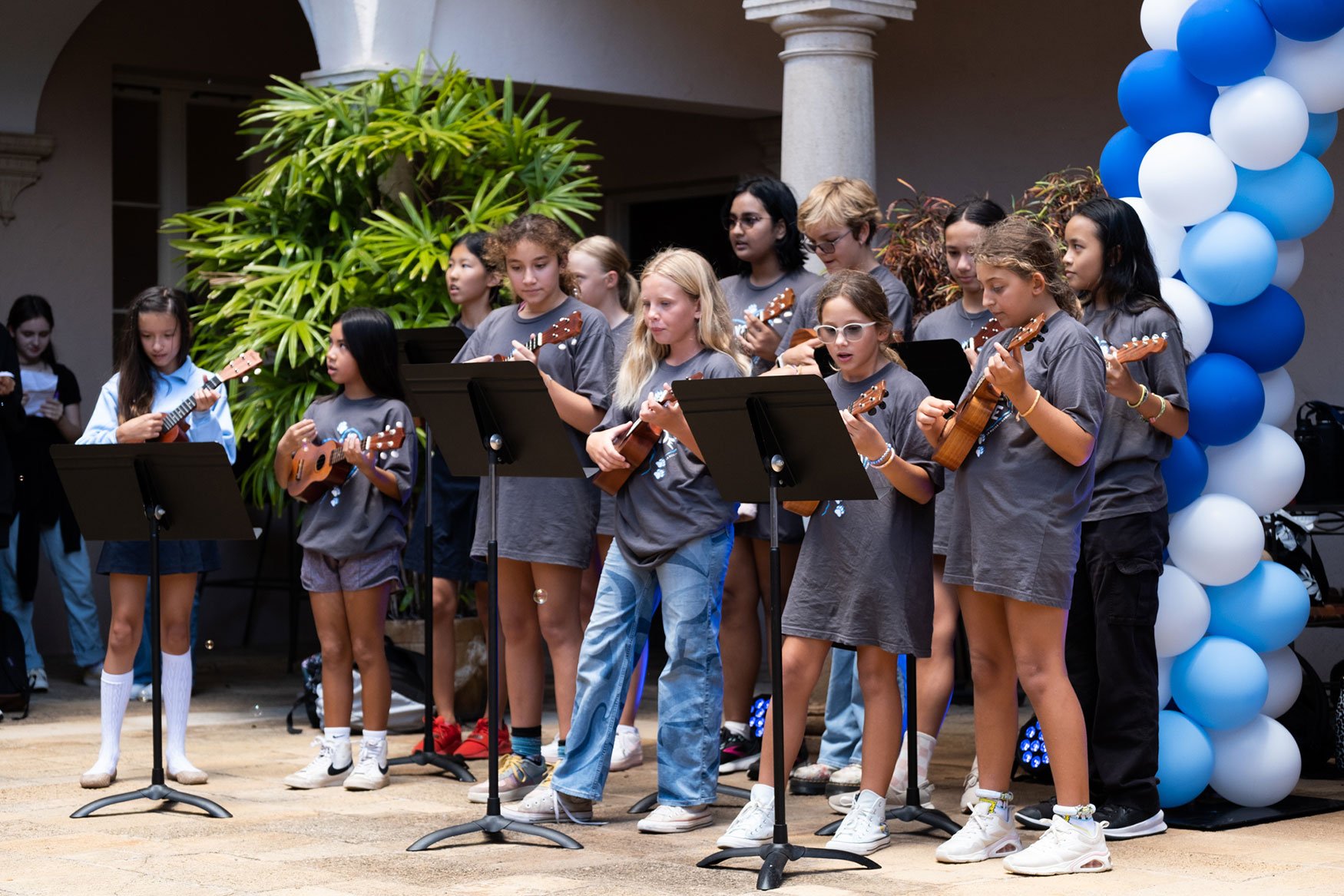 Mr. Ramos and his sixth-grade music class lead the school in singing "Happy Birthday" and the school alma mater, "La Pietra Days."