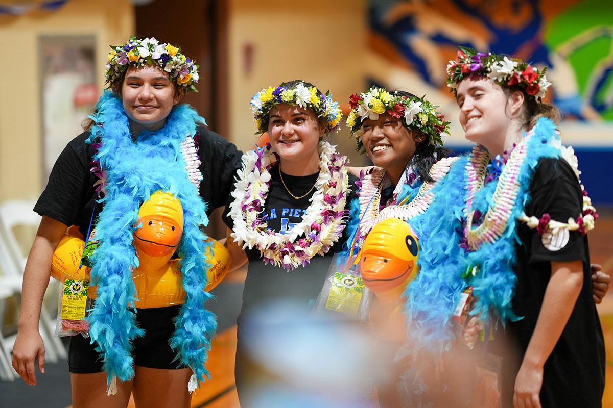 Seniors and Coach Carmen Sharkey '15 celebrate during the varsity volleyball team's senior night in 2023. 