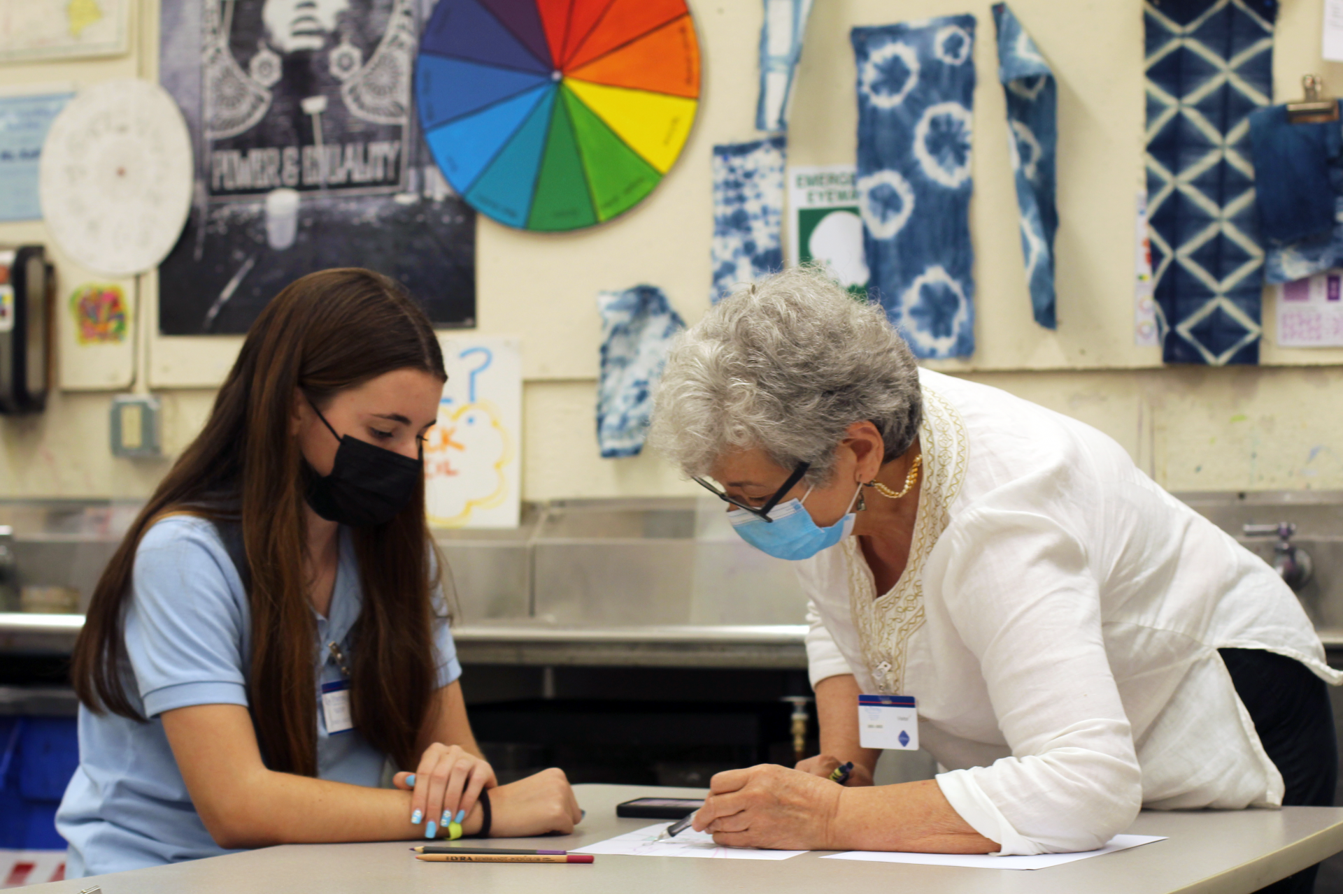 Multimedia Artist Tina Cintron works on drawing projects with students