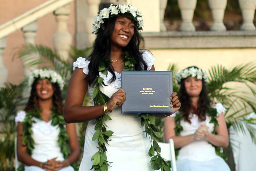 Valedictorian Nina B. receives her diploma.